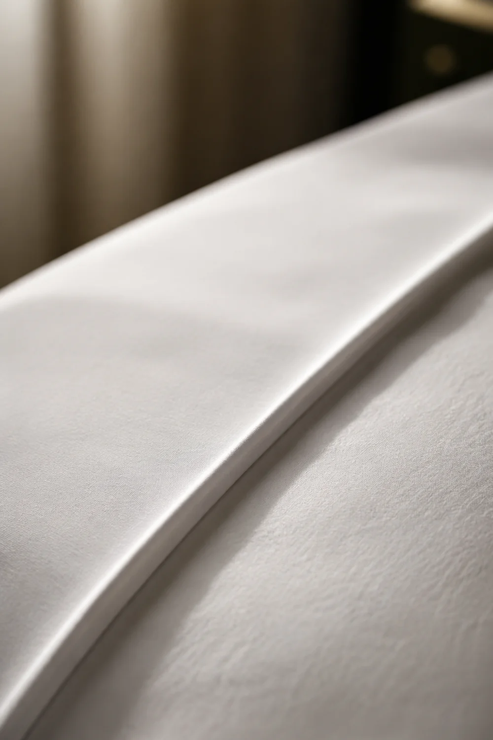 Crisp white flat sheet folded in a clean band over the top of a duvet