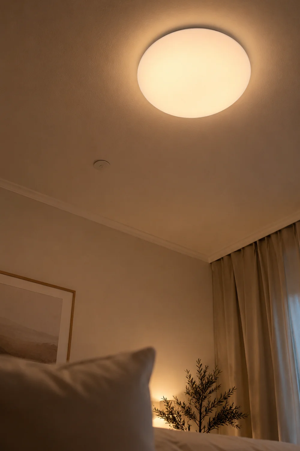 Frosted ceiling light diffuser viewed from a reclined angle in bed to reduce glare