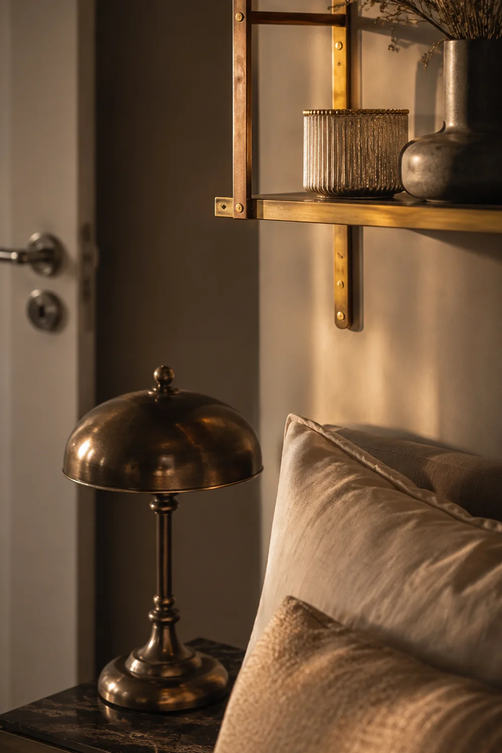Brass picture ledge and bronze lamp base mixed metal bedroom details