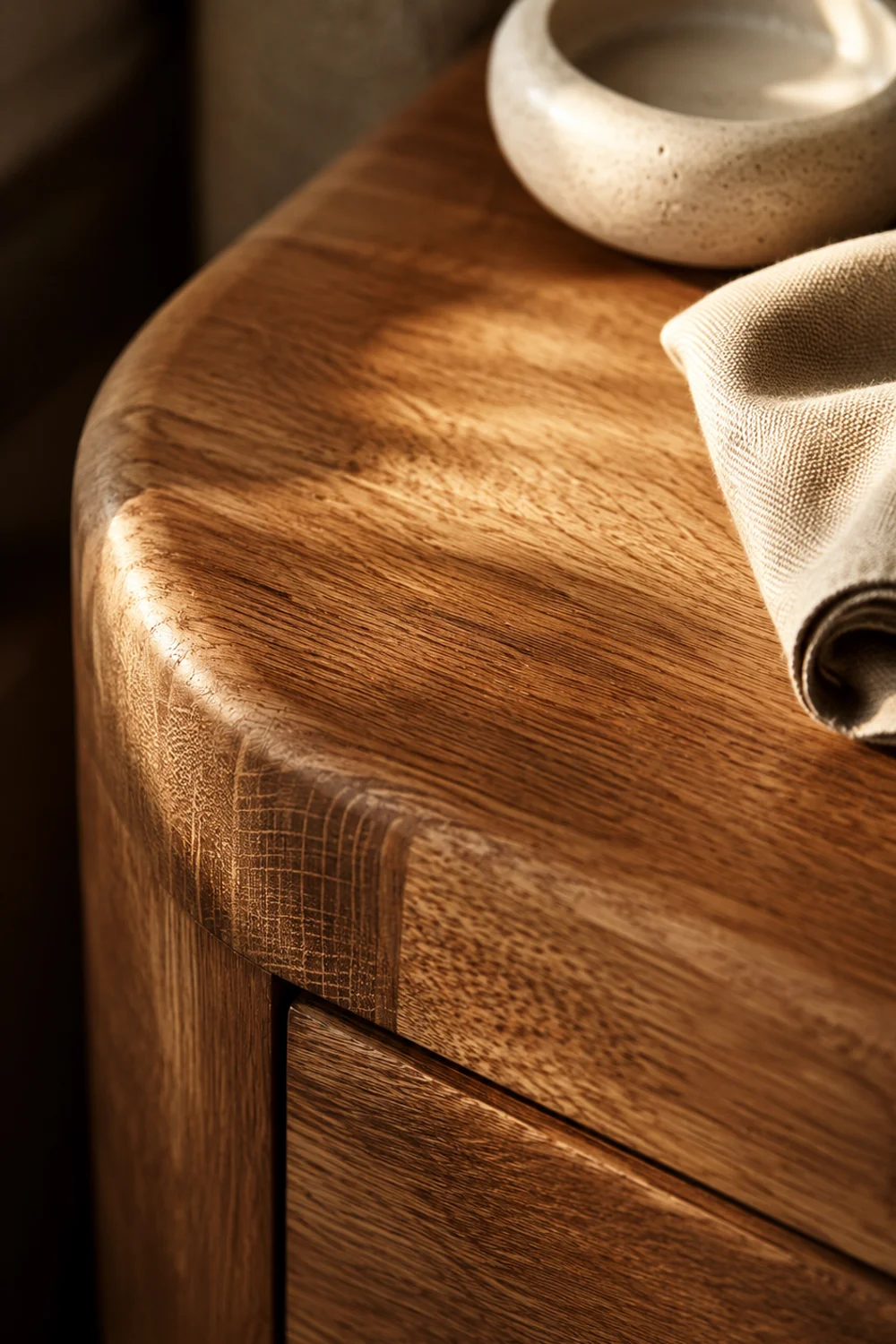 Close-up of solid oak nightstand wood grain with rounded edge