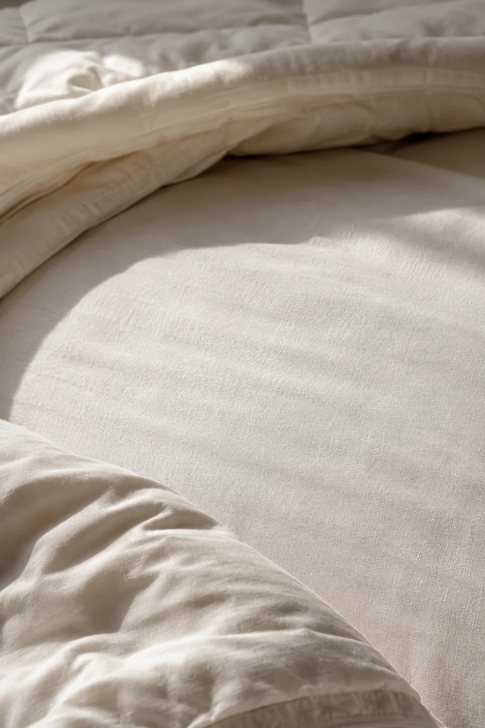 Close-up texture shot of breathable bamboo bedsheet folded back on a bed