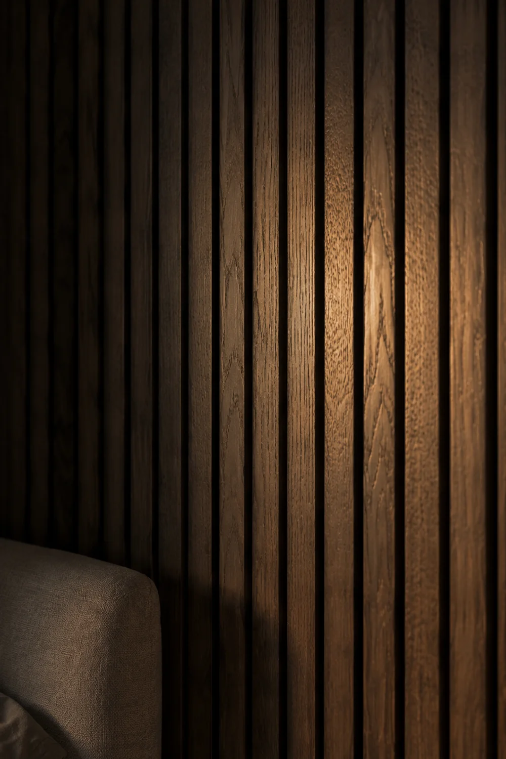 Vertical wood paneling accent wall behind bedroom headboard
