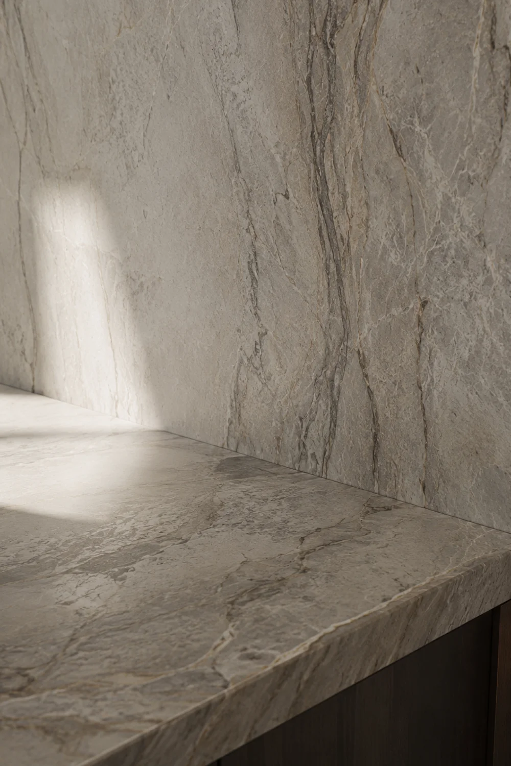 Seamless stone counter and backsplash with continuous natural veining