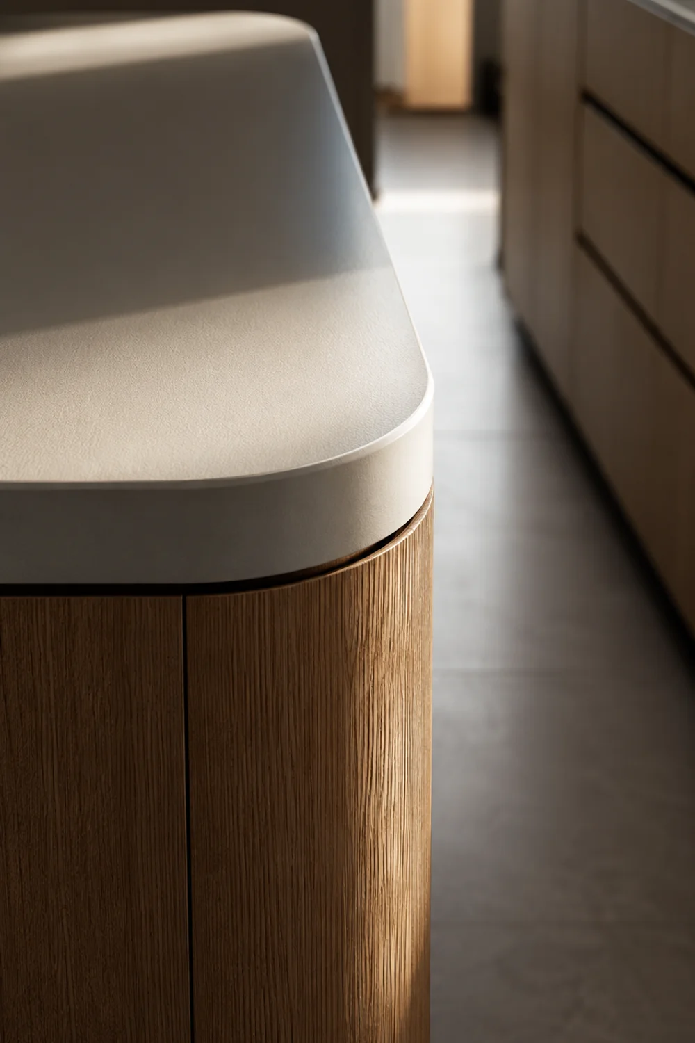 Close-up of a rounded kitchen island corner softening a tight walking path