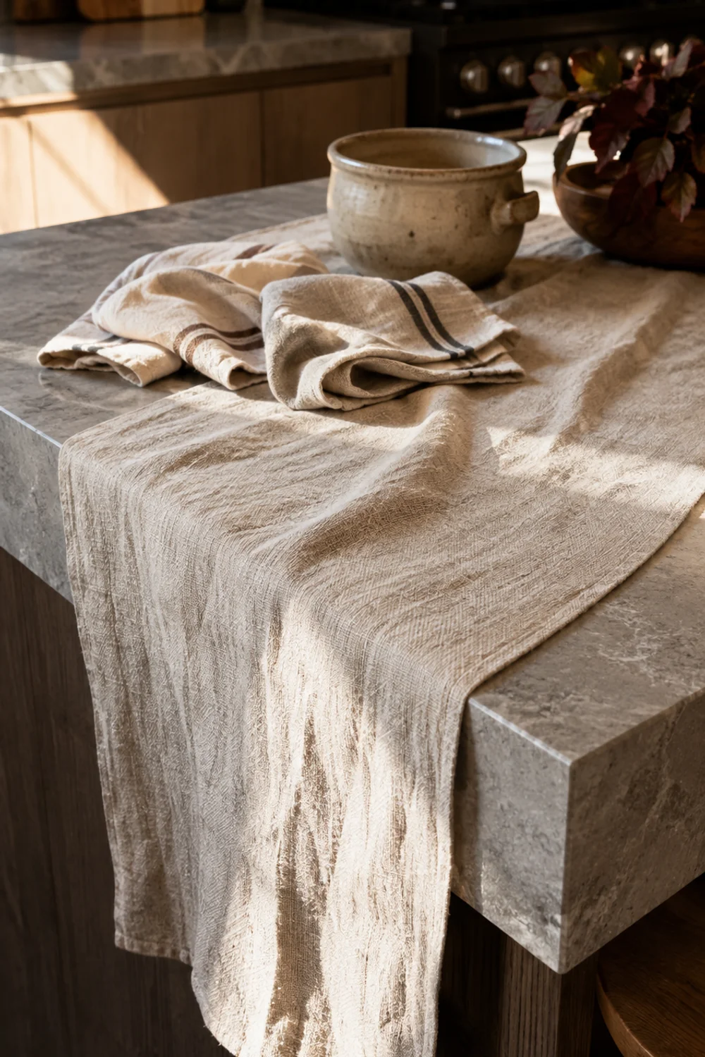 Warm linen table runner draped across a modern kitchen island countertop